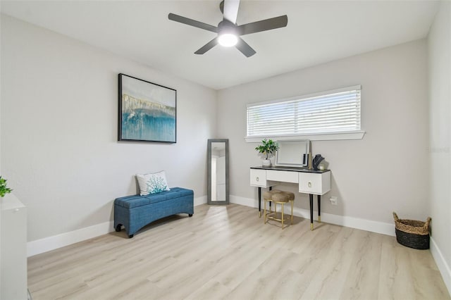 sitting room with baseboards, a ceiling fan, and wood finished floors