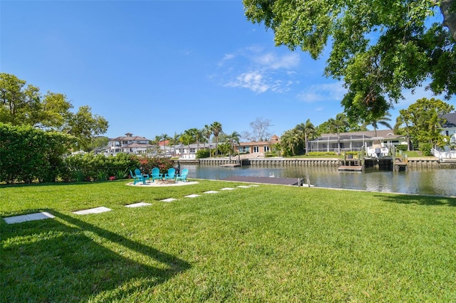 view of yard with a residential view and a water view