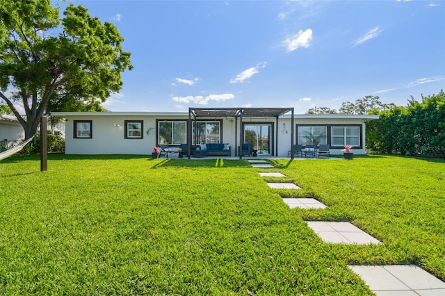 rear view of property with a lawn, stucco siding, a pergola, and an outdoor hangout area
