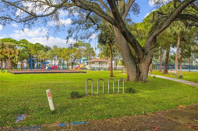 surrounding community featuring a yard and playground community