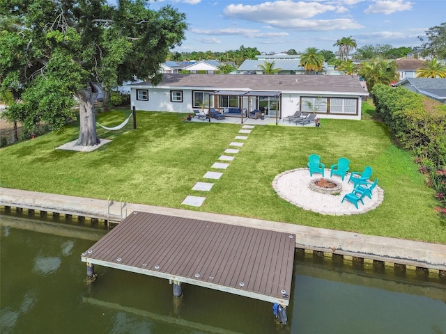 3922 Fontainebleau Dr, Tampa, FL 33634 - back of property featuring an outdoor fire pit, a water view, a patio area, and a yard