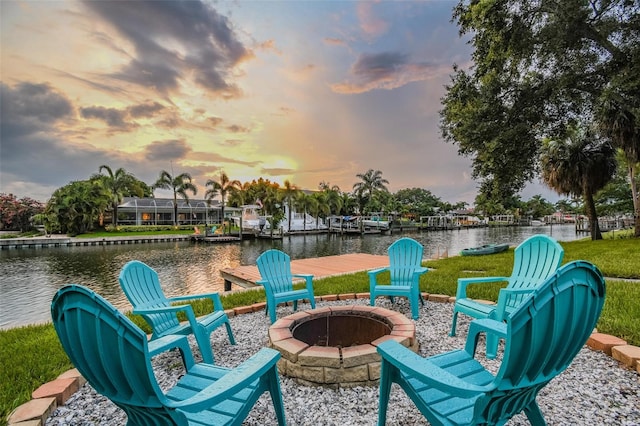 3922 Fontainebleau Dr, Tampa, FL 33634 - patio terrace at dusk featuring an outdoor fire pit and a water view