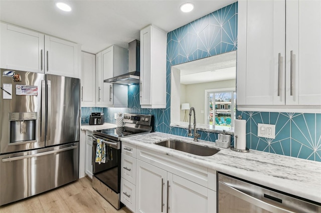 3922 Fontainebleau Dr, Tampa, FL 33634 - kitchen with appliances with stainless steel finishes, wall chimney exhaust hood, a sink, white cabinetry, and recessed lighting