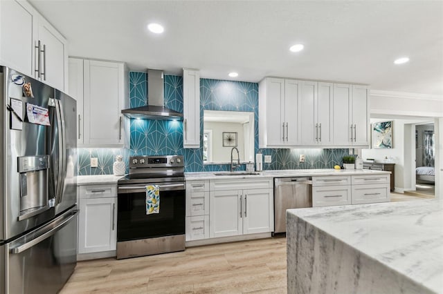 3922 Fontainebleau Dr, Tampa, FL 33634 - kitchen featuring stainless steel appliances, wall chimney exhaust hood, a sink, white cabinetry, and recessed lighting