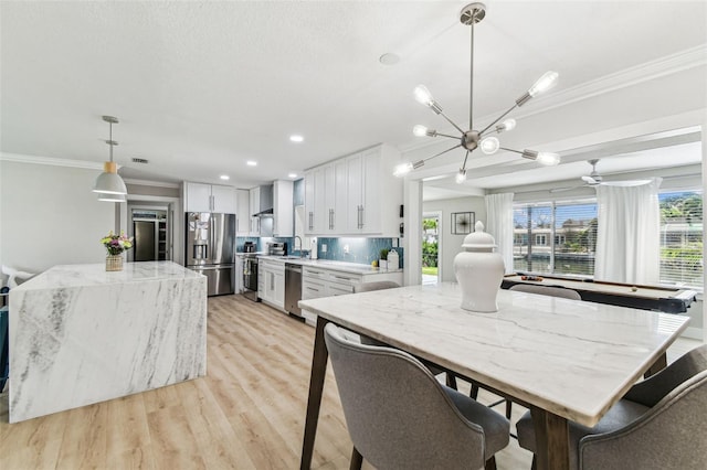 3922 Fontainebleau Dr, Tampa, FL 33634 - dining area featuring ornamental molding, light wood-style flooring, a chandelier, and recessed lighting