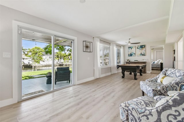 3922 Fontainebleau Dr, Tampa, FL 33634 - living room featuring pool table, plenty of natural light, a water view, and light wood-type flooring