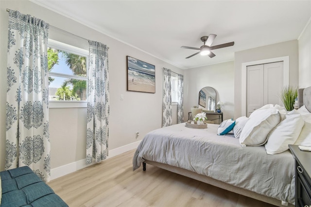3922 Fontainebleau Dr, Tampa, FL 33634 - bedroom with wood finished floors, multiple windows, baseboards, a closet, and crown molding