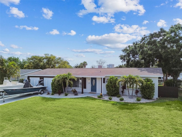 3922 Fontainebleau Dr, Tampa, FL 33634 - ranch-style home with a garage, a front lawn, and brick siding