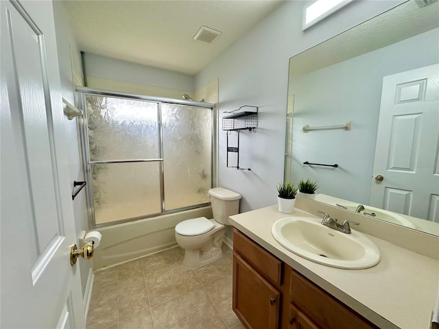 2820 Pankaw Ln, Valrico, FL 33596 - full bathroom with toilet, vanity, shower / bath combination with glass door, and tile patterned flooring