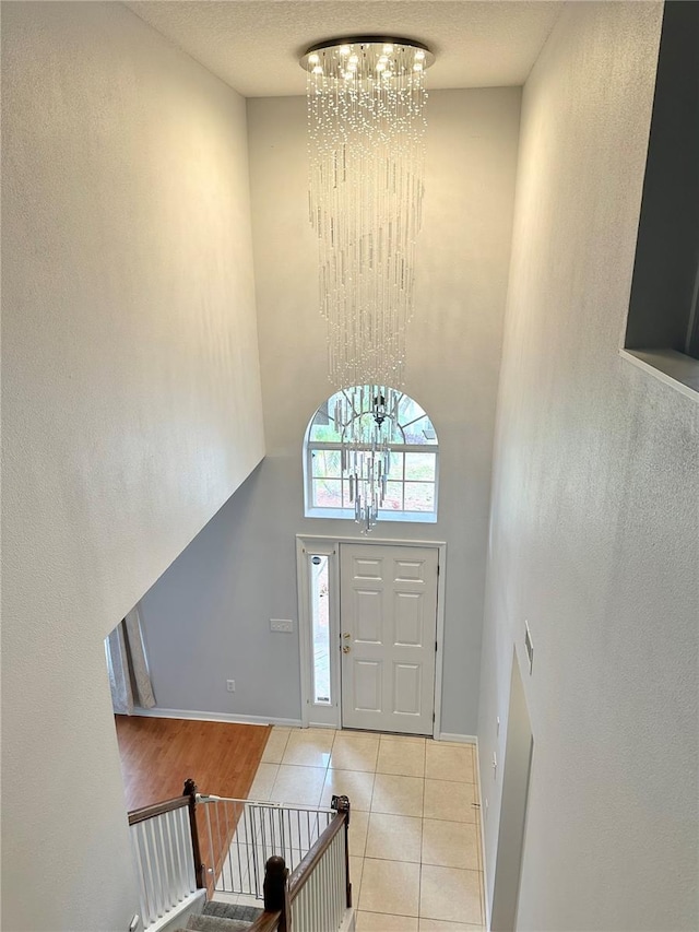 2820 Pankaw Ln, Valrico, FL 33596 - tiled foyer featuring a chandelier, a high ceiling, and baseboards