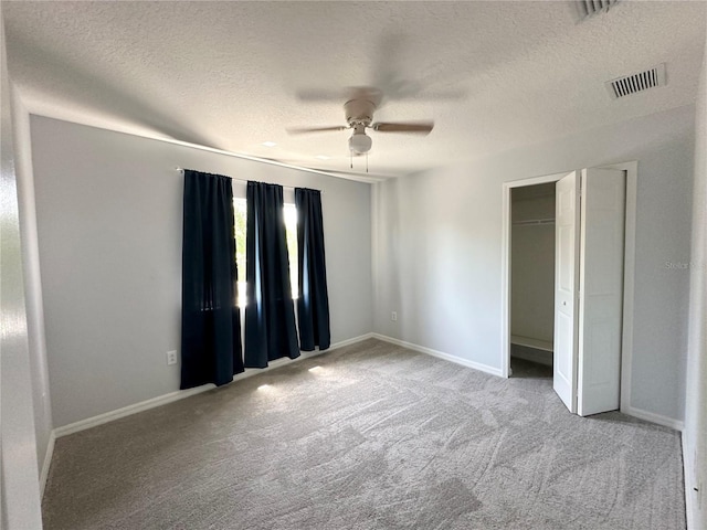2820 Pankaw Ln, Valrico, FL 33596 - unfurnished bedroom with a textured ceiling, carpet floors, baseboards, ceiling fan, and a closet