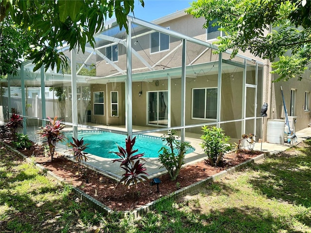 2820 Pankaw Ln, Valrico, FL 33596 - rear view of house with glass enclosure, stucco siding, a patio area, and an outdoor pool