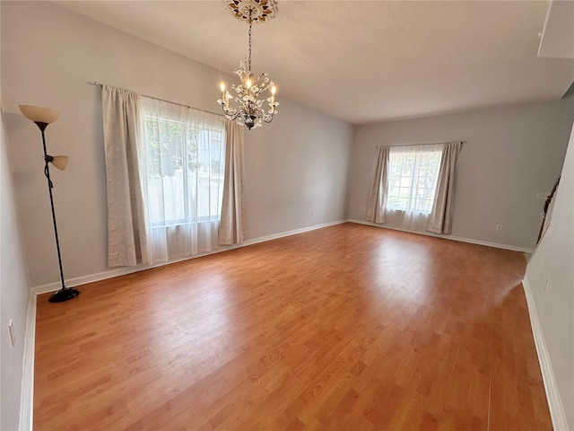 2820 Pankaw Ln, Valrico, FL 33596 - empty room with a chandelier, wood finished floors, and baseboards