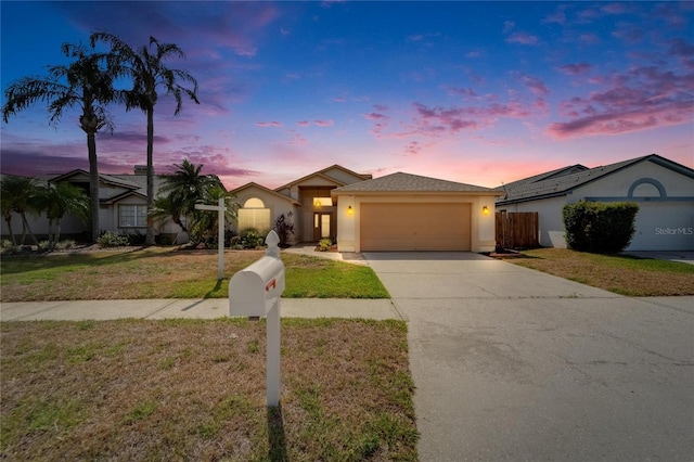 1601 Westerly Dr, Brandon, FL 33511 - view of front of property with driveway, a lawn, a garage, fence, and stucco siding