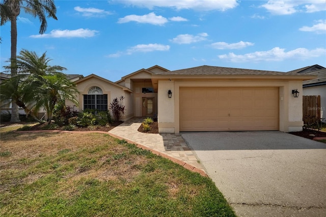 1601 Westerly Dr, Brandon, FL 33511 - view of front of property featuring stucco siding, an attached garage, and driveway