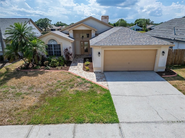 1601 Westerly Dr, Brandon, FL 33511 - view of front of property with fence, a garage, stucco siding, a chimney, and driveway