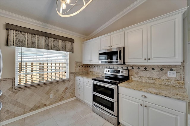 1601 Westerly Dr, Brandon, FL 33511 - kitchen featuring white cabinets, crown molding, appliances with stainless steel finishes, light tile patterned floors, and vaulted ceiling