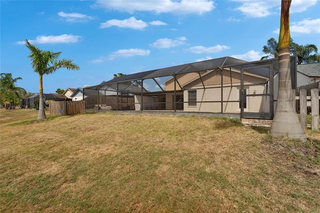 1601 Westerly Dr, Brandon, FL 33511 - back of house featuring a lawn, fence, and glass enclosure