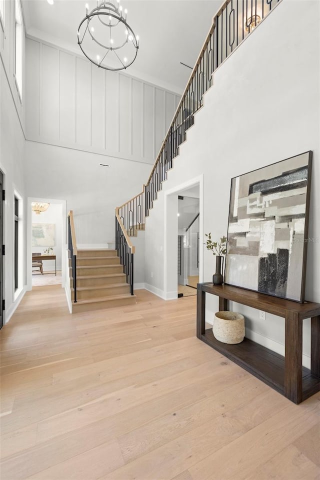 2218 S Occident St, Tampa, FL 33629 - stairway featuring a notable chandelier, wood finished floors, and a towering ceiling