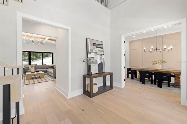 2218 S Occident St, Tampa, FL 33629 - foyer entrance with baseboards, light wood finished floors, and a notable chandelier