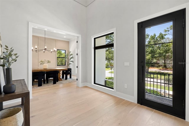 2218 S Occident St, Tampa, FL 33629 - entryway with light wood-style floors, baseboards, a chandelier, and a healthy amount of sunlight