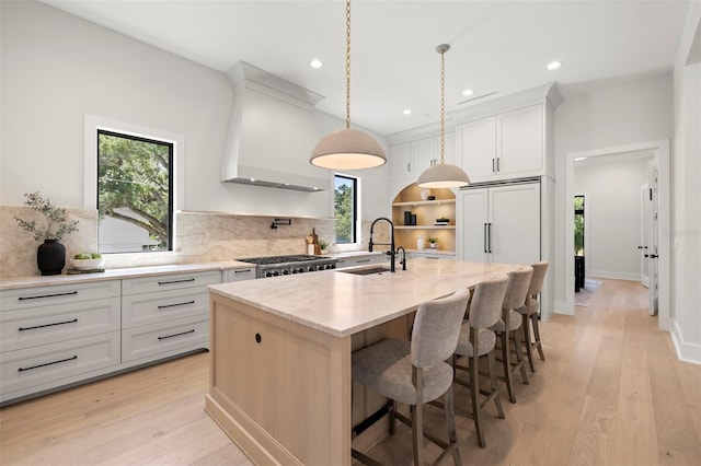 2218 S Occident St, Tampa, FL 33629 - kitchen with a sink, backsplash, custom exhaust hood, and a healthy amount of sunlight
