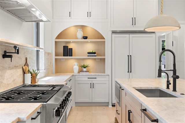 2218 S Occident St, Tampa, FL 33629 - kitchen with open shelves, ventilation hood, a sink, stove, and light wood-type flooring