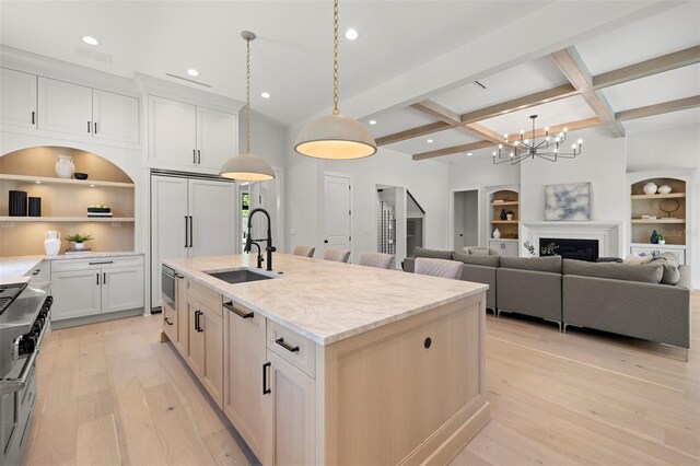 2218 S Occident St, Tampa, FL 33629 - kitchen featuring beam ceiling, a sink, a kitchen island with sink, and built in shelves