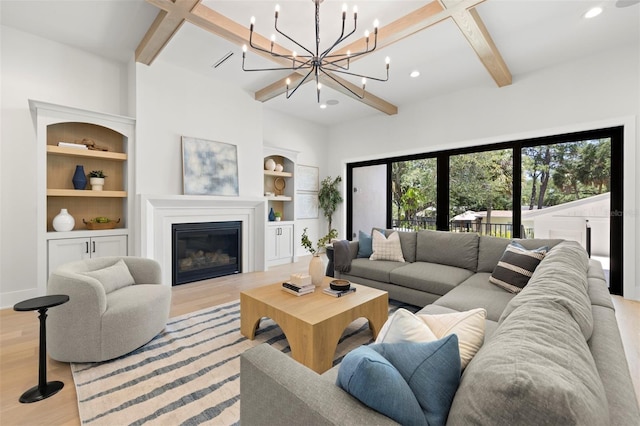 2218 S Occident St, Tampa, FL 33629 - living room featuring beam ceiling, light wood finished floors, a chandelier, a glass covered fireplace, and recessed lighting