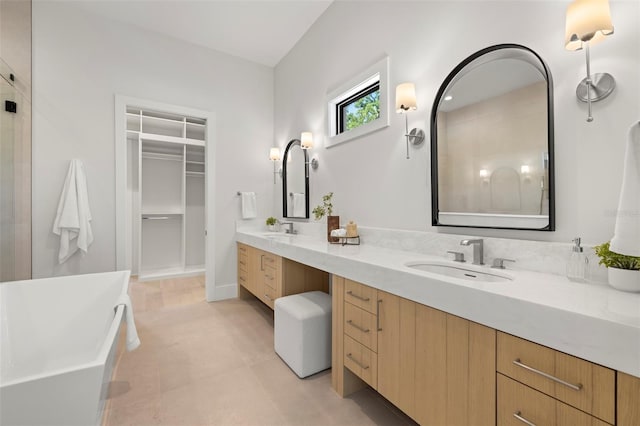 2218 S Occident St, Tampa, FL 33629 - full bath with double vanity, a walk in closet, a freestanding tub, and a sink