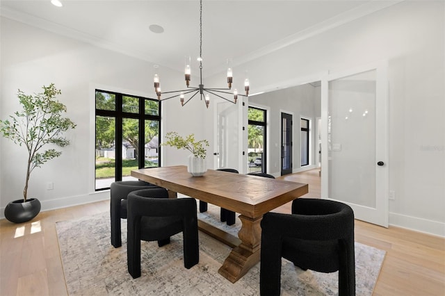 2218 S Occident St, Tampa, FL 33629 - dining area featuring baseboards, light wood-style flooring, a high ceiling, and a chandelier