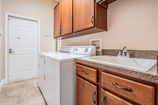 laundry area with a sink, light tile patterned flooring, cabinet space, and washer and clothes dryer