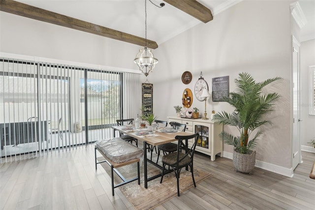 21746 Amelia Rose Way, Land O Lakes, FL 34637 - dining area with a towering ceiling, wood finished floors, beam ceiling, baseboards, and a chandelier