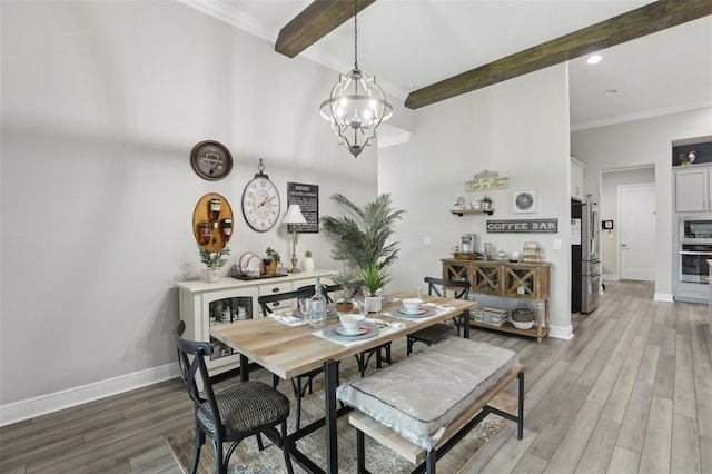 21746 Amelia Rose Way, Land O Lakes, FL 34637 - dining area with crown molding, beam ceiling, a chandelier, baseboards, and light wood-type flooring
