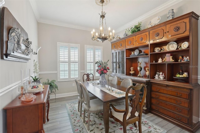 21746 Amelia Rose Way, Land O Lakes, FL 34637 - dining space featuring baseboards, a chandelier, ornamental molding, and light wood finished floors