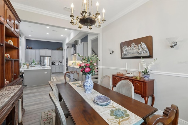 21746 Amelia Rose Way, Land O Lakes, FL 34637 - dining space featuring crown molding, recessed lighting, light wood finished floors, and a notable chandelier