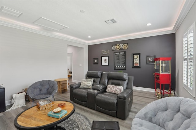 21746 Amelia Rose Way, Land O Lakes, FL 34637 - living area featuring visible vents, attic access, light wood-style flooring, and crown molding