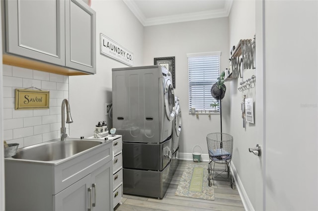 21746 Amelia Rose Way, Land O Lakes, FL 34637 - laundry area with cabinet space, separate washer and dryer, ornamental molding, and a sink
