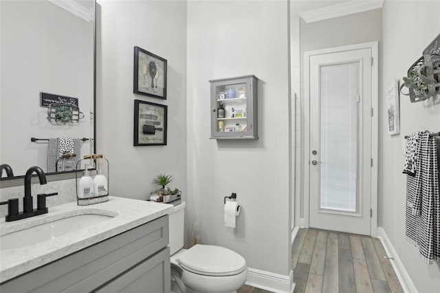 21746 Amelia Rose Way, Land O Lakes, FL 34637 - bathroom with toilet, baseboards, wood finished floors, and vanity