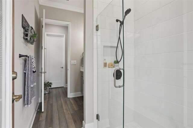21746 Amelia Rose Way, Land O Lakes, FL 34637 - bathroom featuring crown molding, vanity, baseboards, wood finished floors, and a stall shower