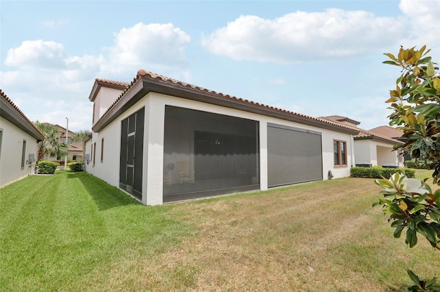 21746 Amelia Rose Way, Land O Lakes, FL 34637 - rear view of property featuring stucco siding, a tile roof, and a lawn