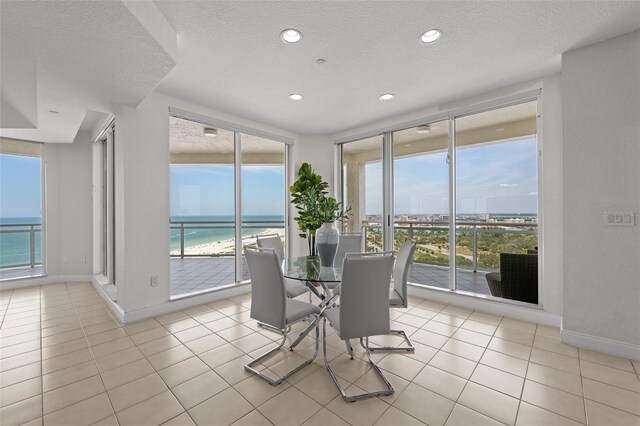 1170 Gulf Blvd Unit 2101, Clearwater Beach, FL 33767 - dining area featuring a textured ceiling, baseboards, a water view, recessed lighting, and light tile patterned floors