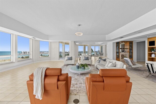 1170 Gulf Blvd Unit 2101, Clearwater Beach, FL 33767 - living room with healthy amount of natural light, a textured ceiling, light tile patterned floors, built in features, and a water view