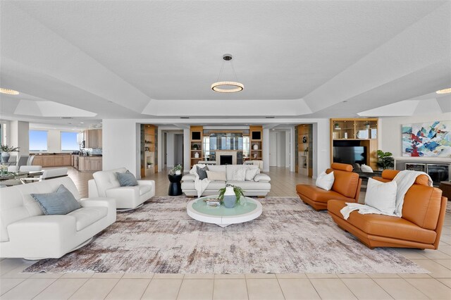 1170 Gulf Blvd Unit 2101, Clearwater Beach, FL 33767 - living area featuring a raised ceiling, a fireplace, and tile patterned floors