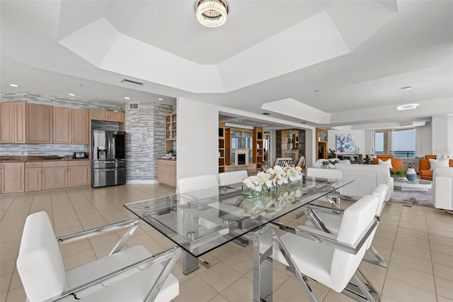 1170 Gulf Blvd Unit 2101, Clearwater Beach, FL 33767 - dining room featuring a raised ceiling and light tile patterned floors