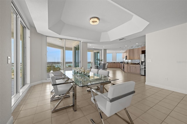 1170 Gulf Blvd Unit 2101, Clearwater Beach, FL 33767 - dining area with a tray ceiling, baseboards, and light tile patterned floors