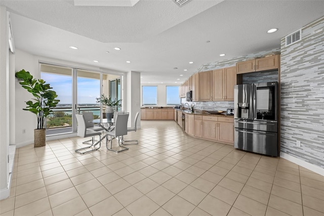 1170 Gulf Blvd Unit 2101, Clearwater Beach, FL 33767 - kitchen featuring refrigerator with ice dispenser, recessed lighting, baseboards, stainless steel microwave, and dark countertops