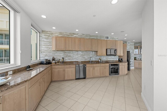 1170 Gulf Blvd Unit 2101, Clearwater Beach, FL 33767 - kitchen with appliances with stainless steel finishes, light brown cabinets, a sink, tasteful backsplash, and dark stone counters