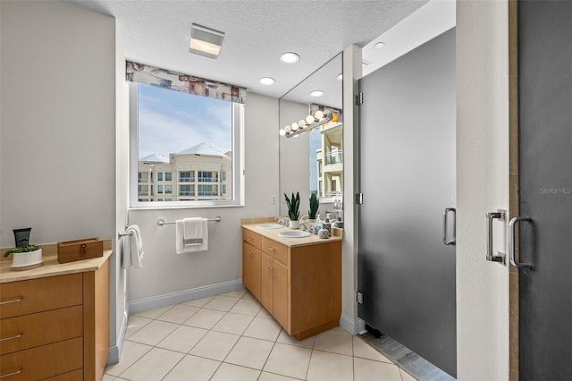 1170 Gulf Blvd Unit 2101, Clearwater Beach, FL 33767 - bathroom featuring baseboards, vanity, recessed lighting, a textured ceiling, and tile patterned floors