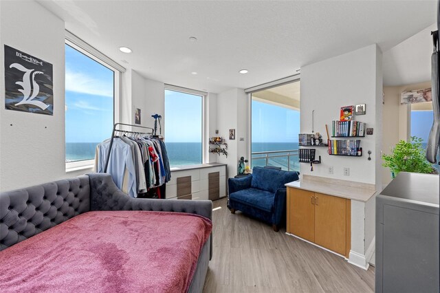 1170 Gulf Blvd Unit 2101, Clearwater Beach, FL 33767 - bedroom featuring light wood-style flooring, multiple windows, a water view, and recessed lighting